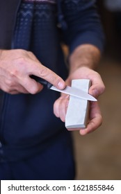 Men Is Sharpening Knife On Stone