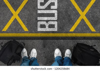 Men With A Shoes And Backpacks Are Standing Next To Bus Stop