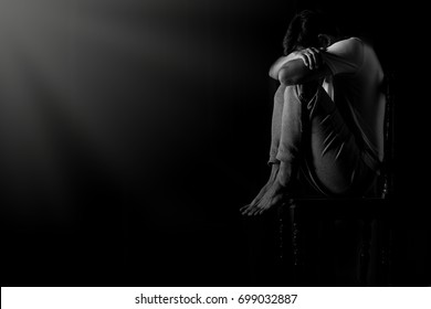 Men sit grief In the dark room because of disappointment in everything in life, both love and duty.