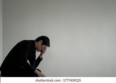 Men sit stressed with problems inside the room. A man is sad and disappointed is lonely. Loneliness and disappointment with life - Shutterstock ID 1777439225
