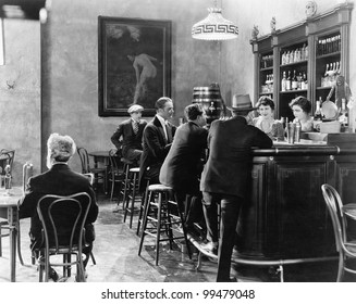 Men sitting around a counter in a bar