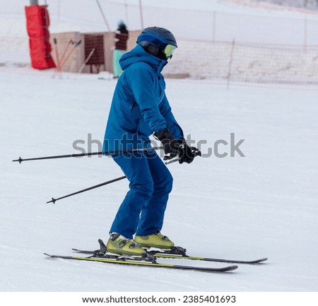 Men ski on snow in winter.