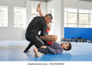 Men sparring, martial arts and fitness in gym with combat, jiu jitsu and students learning self defense skills. Fight, exercise and MMA with fighting sport and male people training at exercise dojo - Powered by Shutterstock