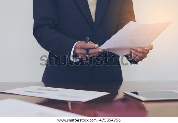 Men Standing Desk Reading Document Hand Stock Photo Edit Now