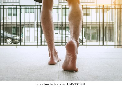 Men Are Stepping Outside. With Barefoot Man