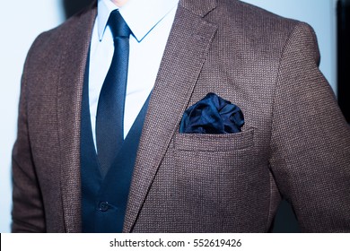 Men Suit Perfect To The Last Detail.Man Posing In Brown Suit
