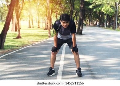 Men tired after jogging in the Park. Tired runner man breathing taking run break in the park having rest after workout. Healthy exercise concept. - Powered by Shutterstock