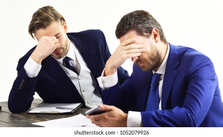 Men In With Tired, Worried Faces Read About Business Fail. Partners In Formal Suits Look At Smartphone. Bad Luck, Lack Of Money, Company Failure. Domino Effect And Failed Business Concept.