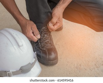 Men Are Tying Safety Shoes.