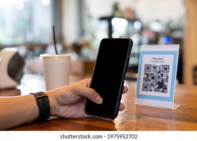 Men Use Phones To Scan A Qr Code To Select A Menu Or Scan To Receive A Discount Or Pay For Food And Drink Inside A Cafe. Using The Phone To Transfer Money Or Pay Online Without Cash Concept.