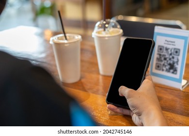 Men Use Phones To Scan A Qr Code To Select A Menu Or Scan To Receive A Discount Or Pay For Food And Drink Inside A Cafe. Using The Phone To Transfer Money Or Pay Online Without Cash Concept.