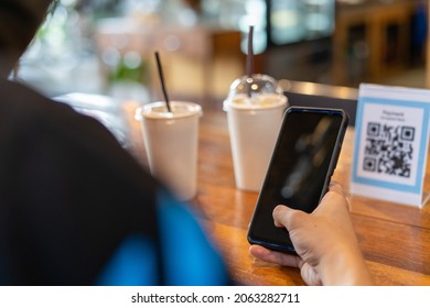 Men Use Phones To Scan A Qr Code To Select A Menu Or Scan To Receive A Discount Or Pay For Food And Drink Inside A Cafe. Using The Phone To Transfer Money Or Pay Online Without Cash Concept.