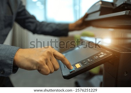 Men use photocopy or copier machine office workplace equipment for make a copy paper or photocopier for scanning document and photocopying service maintenance concepts.