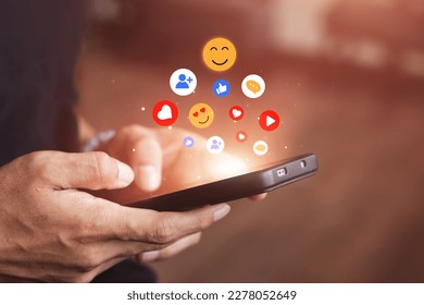Men use smartphones to interact with social media. following news, communicating with others through emojis and online messages, notifications, opinions, or internet digital marketing creation. - Powered by Shutterstock