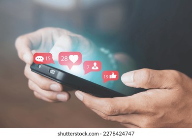 Men use smartphones to interact with social media. following news, communicating with others through emojis and online messages, notifications, opinions, or internet digital marketing creation. - Powered by Shutterstock