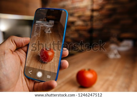 Men using artificial intelligence on smart phone with augmented reality application for recognizing food