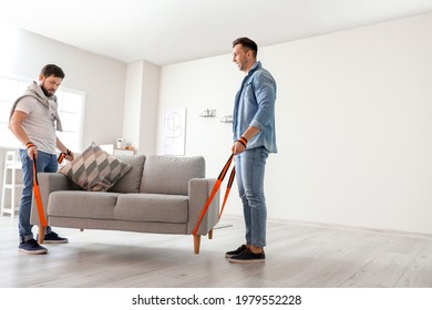 Men Using Cargo Belts For Carrying Furniture