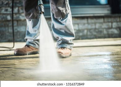 Men Using Pressure Washer For Driveway Cleaning.