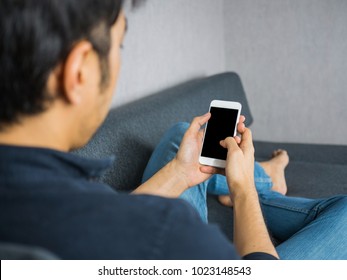 Men using smart phone on sofa - Shutterstock ID 1023148543