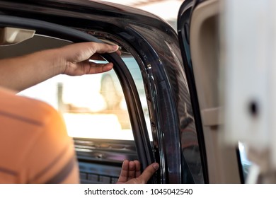 Men Are Using Their Hands To Remove The Soundproofing In The Car.