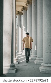 men walking and posing with colums 