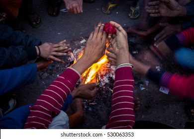 Men Warm Their Hands By A Fire At A Lane In Old Delhi, India On A Winter Morning.  