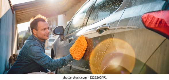 Men Washing His Car With Wash Mitt At Home Backyard