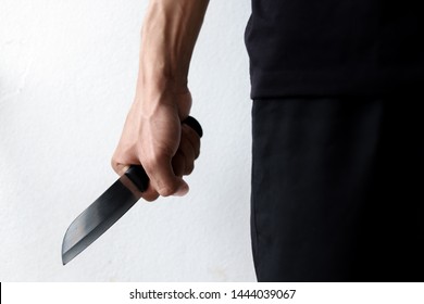 Men wearing black clothes in knives he is very angry and angry and he is going to use a knife to hurt others and there are black men who are going to use weapons that are knives to fight with others