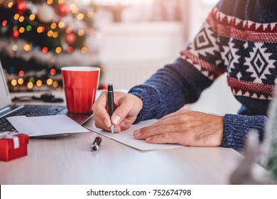 Men Wearing Blue Sweater Writing Greeting Cards At Home Office During Christmas