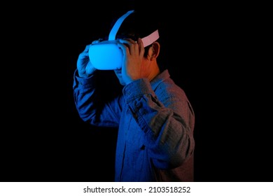 Men is wearing VR headset to connect the virtual reality world.  - Shutterstock ID 2103518252