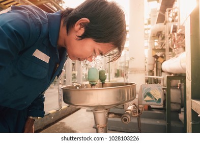 Men were exposed to chemicals and eye washing with eyewash station in chemical factory - Shutterstock ID 1028103226