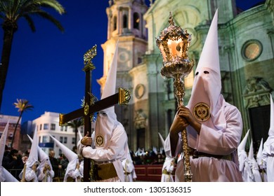 Men In White Robes With Crucifix's At Semana Santa Festival At Night. Cadiz, Spain April 2018