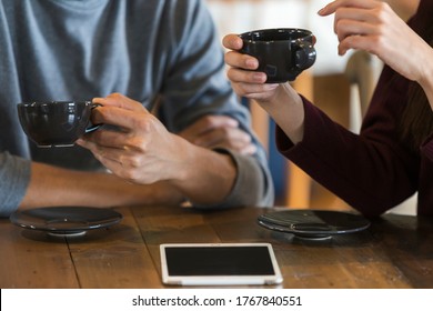 Men and women chatting in a cafe - Powered by Shutterstock