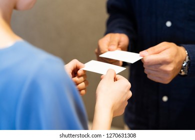 
Men And Women Exchanging Business Cards