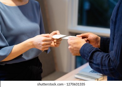 
Men And Women Exchanging Business Cards