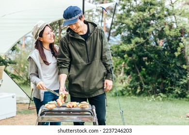 men and women having a barbecue - Powered by Shutterstock