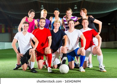 Men And Women In Mixed Sport Team Playing Football Or Soccer Indoor