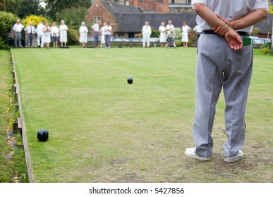 Men And Women Playing Flat Lawn Bowls. Focus On The Man In The Foreground