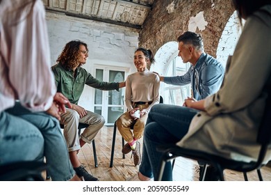 Men And Women Sitting In A Circle During Group Therapy, Supporting Each Other. Selective Focus