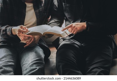 Men And Women Sitting Studying The Bible With Light Shining From Behind . The Concept Of Studying The Bible . Religious School.  Sunday