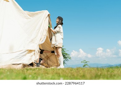 Men and women in their 20s pitching tents - Powered by Shutterstock