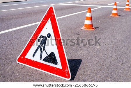 men at work sign at a construction site - photo