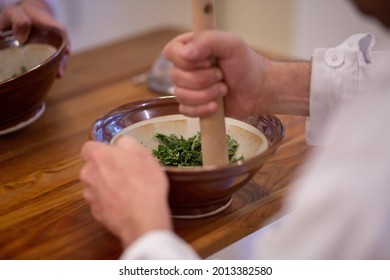 Men Working In A Laboratory With Medical Herbs. Shredding Herbs