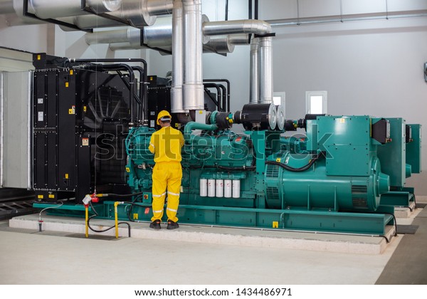 Men working on diesel\
generator