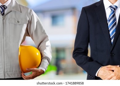 Men In Workwear And Businessmen In Suits