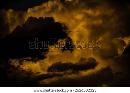 Menacing and storm clouds tower in the spring-time evening sky.