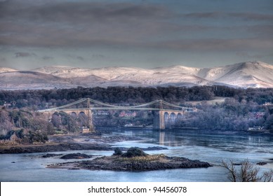 Menai Bridge In Winter With Snow On The Snowdonia National Park North Wales