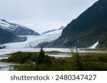 Mendenhall Glacier and Nugget falls. Unrecognizable tourists in the landscape. Alaska. 