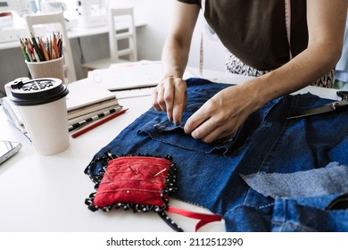 Mending Clothes, How To Mend Old Clothes. Sustainable Fashion, Denim Upcycling Ideas, Using Old Jeans, Repurposing, Reusing Old Jeans, Upcycle Stuff. Woman Seamstress Cut And Repair Old Blue Jeans