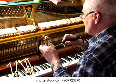  Mending and tuning of the old piano - Shutterstock ID 607923290